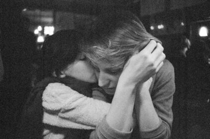 Two people embracing in a dimly lit setting